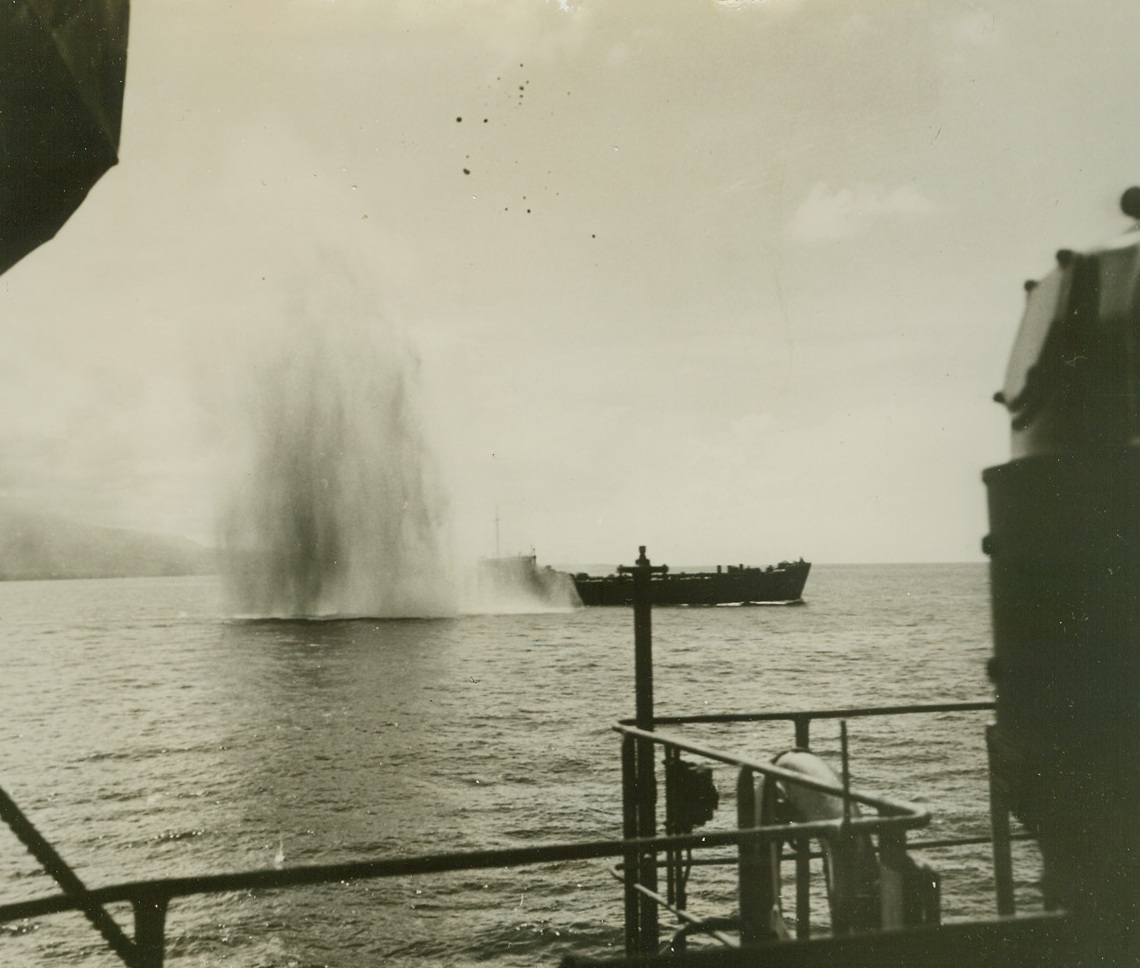 Close, But no U.S. Landing Ship, 1/10/1944. The crews of two coast guard-manned ships heave a relieved sigh as a Jap bomb plunges between the pair of vessels aiding in the invasion of Cape Gloucester, New Britain.  The ships are packed with Marines and equipment, both ready for the push ashore.Credit (U.S. Coast Guard photo from ACME;