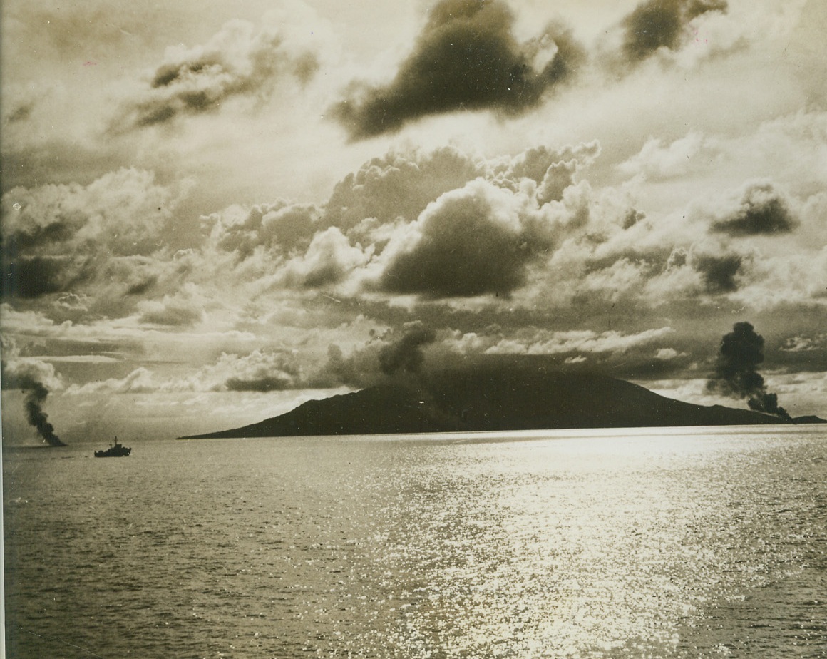 Jap Warbirds Crash at the Cape, 1/8/1944. Cape Gloucester, New Britain – Only thin columns of black smoke remain of three Jap planes that attempted to attack Coast Guard and Navy-manned LSTs invading Cape Gloucester.  The pyres burn at extreme left, center, and extreme right of photo, marking the spots where the ill-fated attackers plunged into the sea.Credit Line (U.S. Coast Guard photo from ACME);