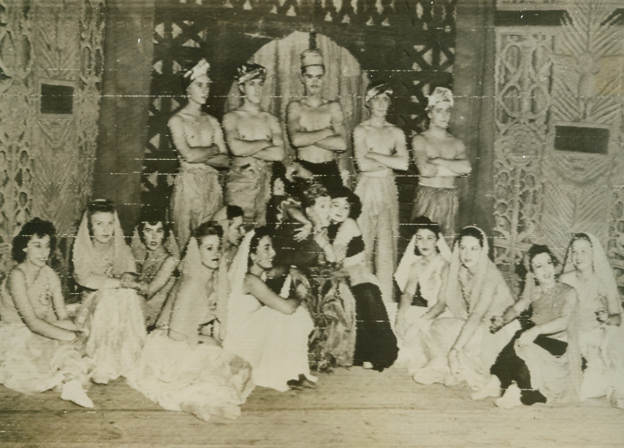 The WAC Swing, 1/5/1944. Algiers – S/Sgt Danny Webb of Hollywood, Calif., and Pfc Ona Freeman (both front center) of Kansas City, Mo., take the spotlight in this scene, the Harem number, from the all-soldier WAC musical comedy “Swing Sister WAC, Swing”.  The revue was presented at the Algiers Opera House, to the delight of all servicemen stationed there.  Credit (ACME photo by Charles Seawood for War picture pool, transmitted via Signal Corps radio telephoto);