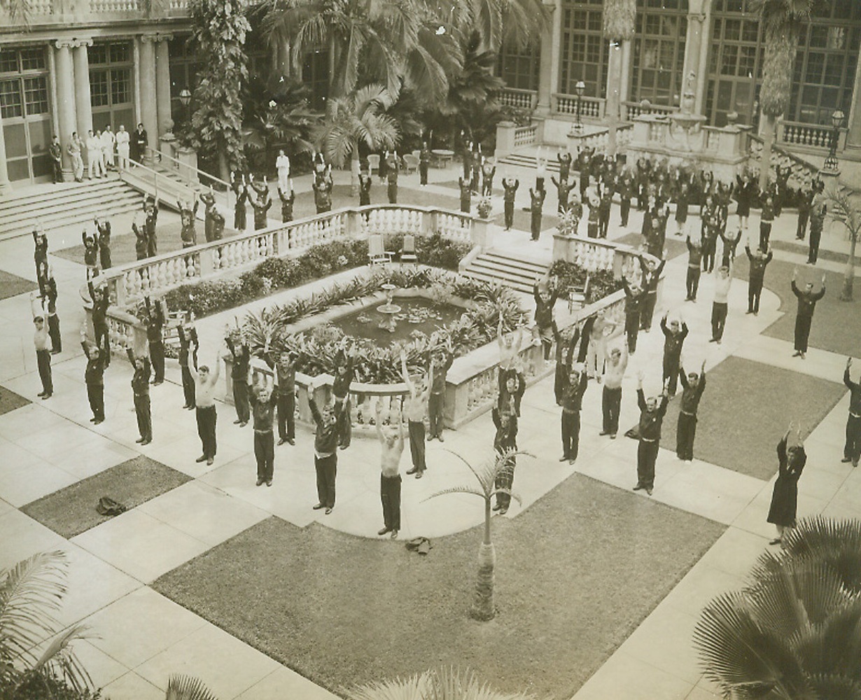 Getting Back Strength Under Florida Sun, 1/3/1944. Palm Beach, Fla—A bunch of husky, or near-husky soldiers doing their calisthenics is a strange sight in the patio of the exclusive Breakers Hotel, in Palm Beach. Now the Ream General Hospital, the former luxurious winter home of wealthy vacationists houses soldiers just returning from war theaters and those injured in U.S. camps. The wounded fighters may have to find a new place to relax and grow healthy if the onetime hotel is returned to its owners. Credit: ACME.;