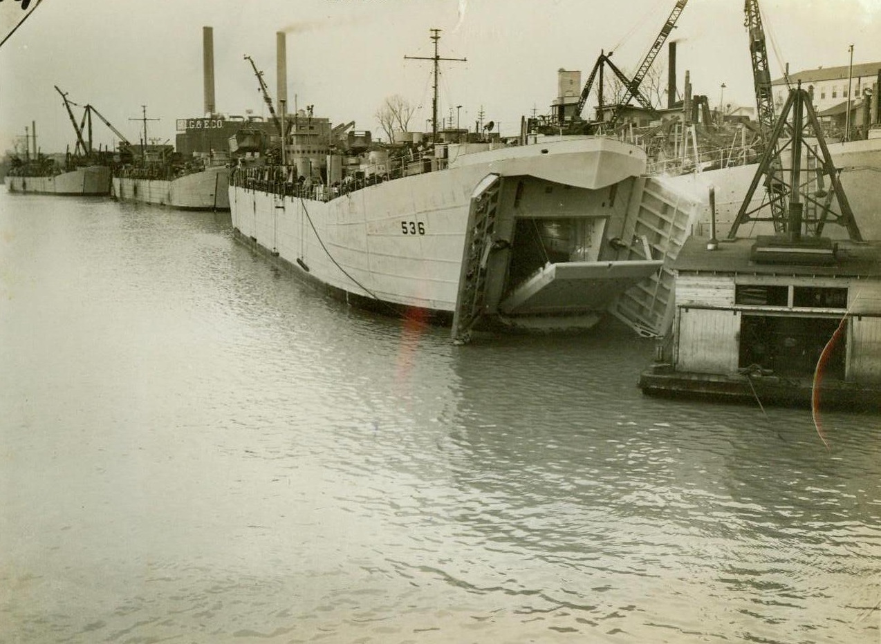 Shipbuilding brings boom to Evansville, 1/29/1944. Evansville, Ind.: Built on waste land, the two year old shipbuilding plant of the Missouri Valley Bridge and Iron Company, has been credited with producing a greater tonnage of ocean-going vessels than any other inland shipyard of the world, last year, and the Navy has its order to double last year’s quota! The company builds the Navy’s ugly-duckling, landing ships for tanks or LST as they are known in the service. Photo shows; LST vessels in the Ohio River ready for movement to the sea, 1,660 miles away! CREDIT LINE (ACME) 1-29-44;