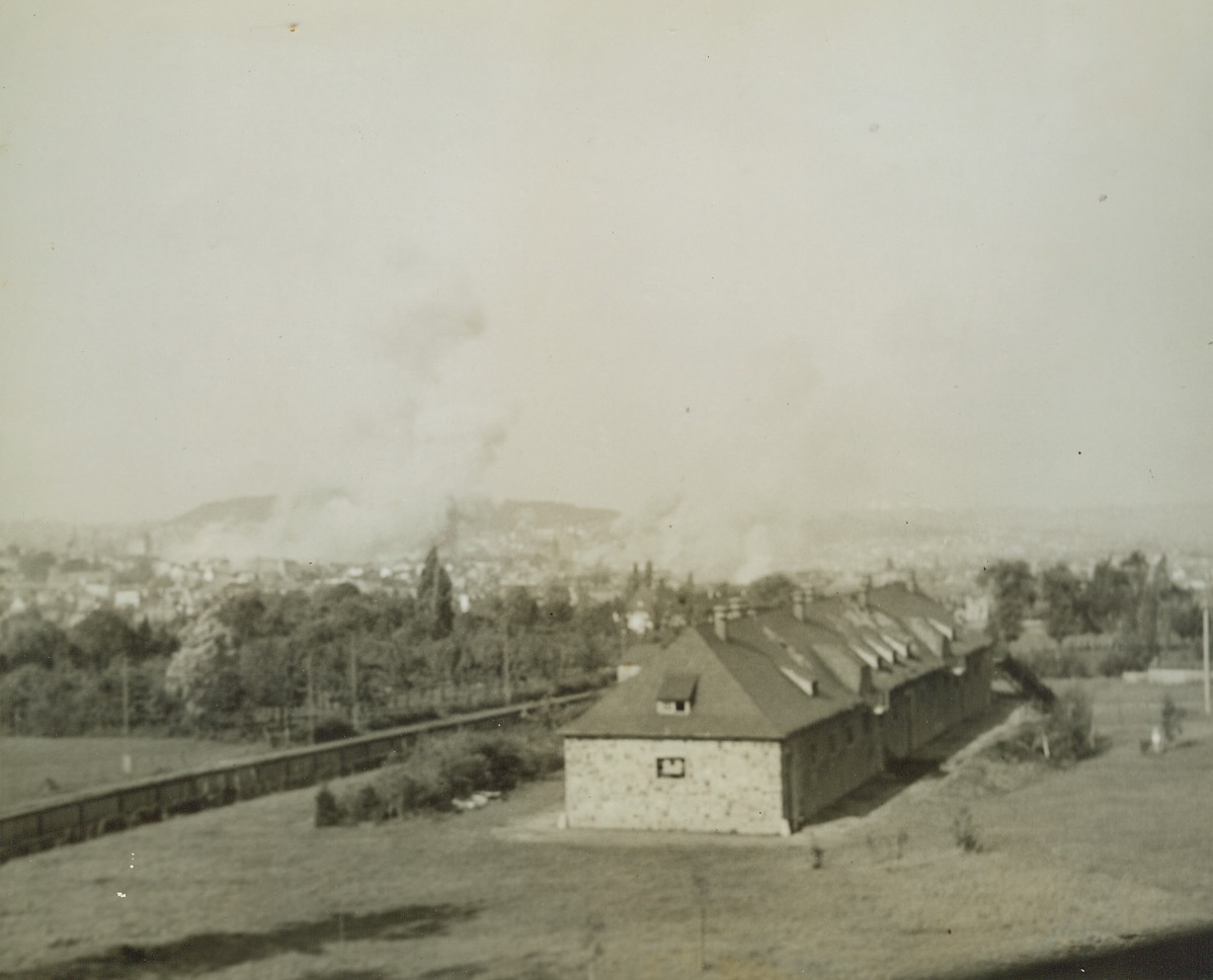 AACHEN UNDER PALL OF SMOKE, 10/19/1944. GERMANY—Clouds of smoke rise above the ancient German city of Aachen after a concentrated Allied bombing attack.Credit: Photo by Acme photographer, Andrew Lopez, for the War Picture Pool;