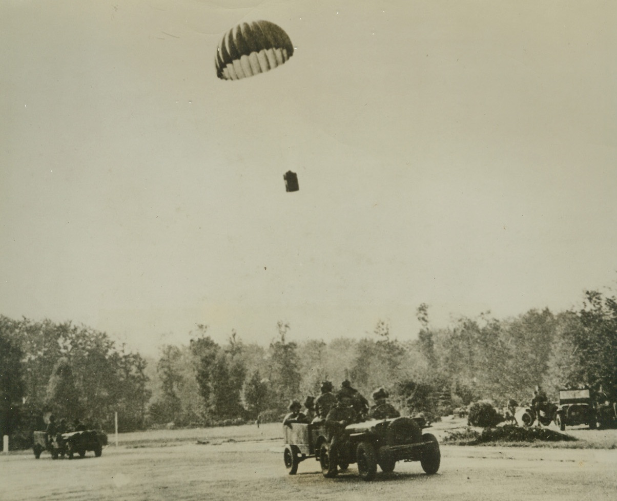 Supplies for Trapped Warriors, 10/2/1944. HOLLAND – Settling slowly to earth, a supply basket ‘chutes to waiting men of the First Allied Airborne Army in Holland. Of the 8,000 who dropped in the air invasion and were later forced to abandon their positions, only 2,000 warriors managed to get out safely. Credit (British Official Photo from ACME);