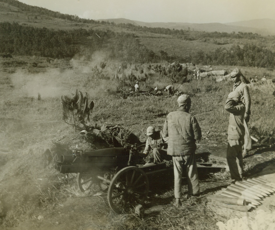 Tengchung Captured from Japs, 10/4/1944. China – The first city East of Burma to be liberated by the Allies, the ancient Jade center of Tengchung has been captured from the Japs after five bloody weeks of fighting.  Here, during the early part of the fighting, 77mm, howitzers made in the U.S. throw shells into Jap positions in the city from atop the surrounding mountains.Credit Line (ACME photo by Frank Cancellare for War Picture Pool);