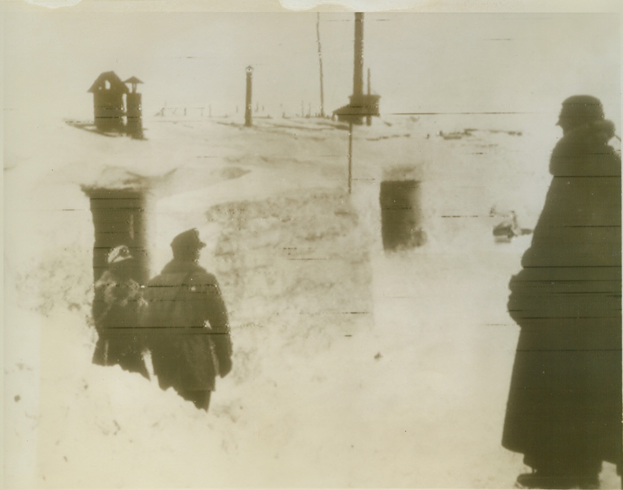 Ready for Hot Time on a Cold Front, 2/8/1944. Finland – Nazi soldiers under command of General Dietl, German chief of the Finnish front, use ice walls and snow roofs to “insulate” their wooden barracks from the piercing cold. As Russia promises heavier blows at Finland, the snowbound Nazi fighters may soon see grim action. (Photo flashed from Stockholm to New York) Credit (ACME Radiophoto);