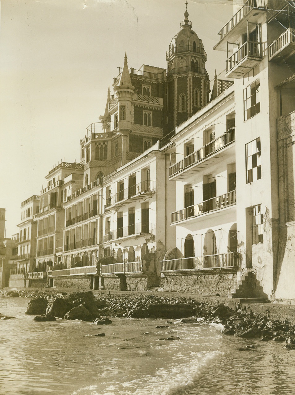 10,000 Homeless on a Single Farm, 2/24/1944. ITALY – The 14,000-acre farm of Prince Stephano Borghese is proving a welcome, if highly uncomfortable haven for approximately 10,000 Italian civilians who where ordered from Anzio and Nettuno by Hitler, last November 1. Planning to use the beautiful seaside towns as rest centers for German troops, Hitler drove out the natives who were allowed only the possessions they could carry. Prince Borghese, head of an old and wealth Italian family, opened his nearby farm to the refugees who now live, for the most part, in straw huts of their own making. The Allies have already made violent alterations in Hitler’s plans for an Anzio-Nettuno rest center, and as soon as possible the civilians will return to their homes. In the meantime, Acme War Pool Photographer Bert Brandt shows you how they live.New York BureauSome of the beautiful homes which the townspeople were ordered to evacuate look out over the water, lining the beach between Anzio and Nettuno. Now, the onetime residents of these houses are jammed into thatched huts that have no conveniences.Credit (Acme Photo by Bert Brandt, War Pool Photographer);