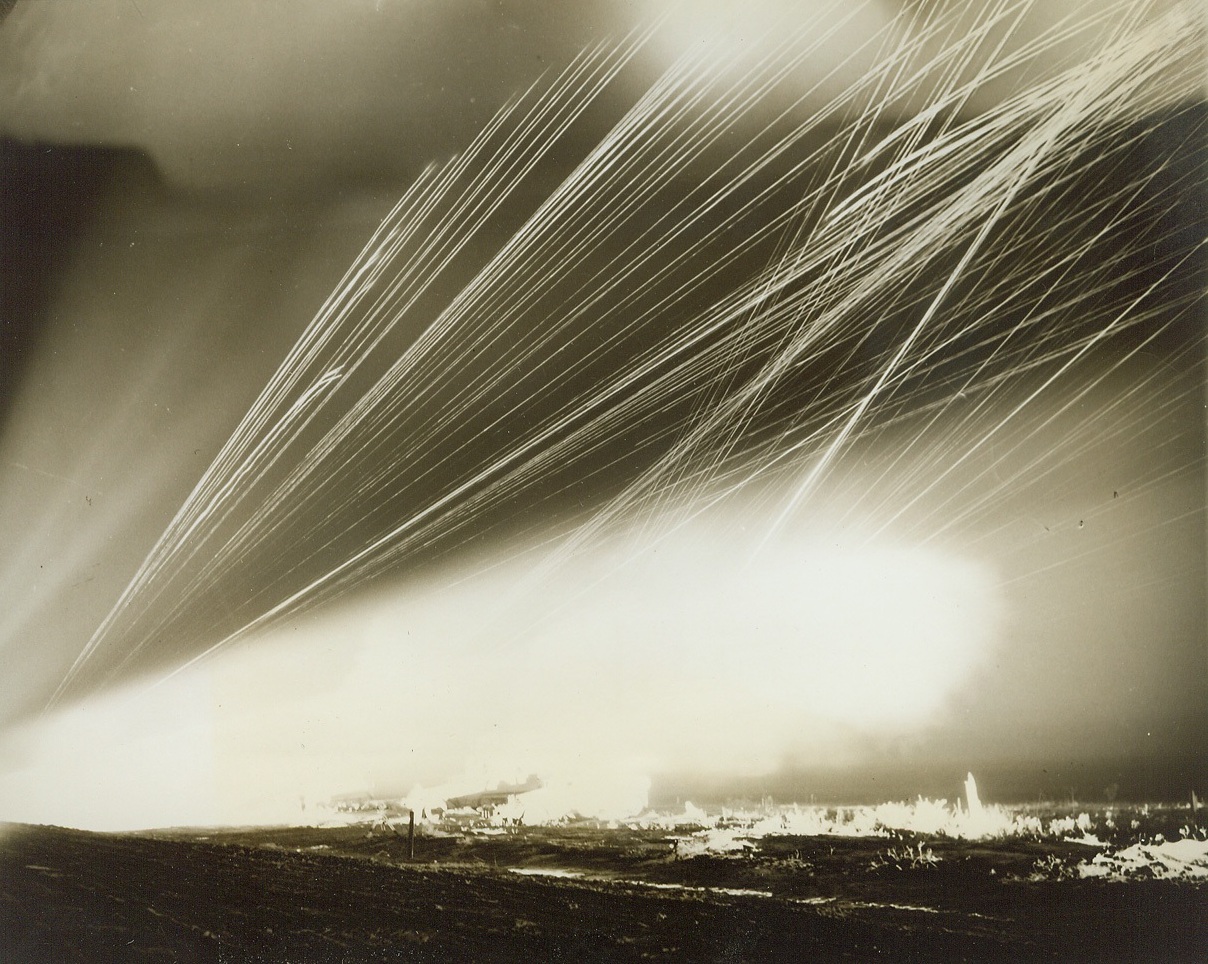 Rocket Targets for Ack-Ack Training, 2/8/1944. CAMP DAVIS, N.C. -- Jet-propelled rocket targets are now being used to train anti-aircraft artillerymen at Camp Davis, giving our gunners practical experience in firing at "enemy planes" diving at terrific speed, and preparing them for action against the jet-propelled planes of tomorrow, should the enemy perfect such planes before this war is over. Fired from specially designed carriages, the rockets have an initial velocity of 450 miles per hour or 675 feet per second. They are released from the range at Holly Shelter, a Camp Davis firing point. Manning 50 caliber machine guns and 20 and 40mm weapons, the trainees improve their aim and accuracy as the track the fast-moving, 59-inch targets. The rocket always describes an approximate parabola and has a maximum horizontal range of about 2200 yards. The following photos show phases of rocket target practice by night and by day.  New York Bureau Their guns mounted on half-tracks that shine white in the light of mock battle, the gunners trace lines of fire across the black sky as they get a deadly bead on the rocket targets. The half-tracks are driven speedily up and down the range as the crews pour lead at their targets at a rate of better than 1600 rounds per minute. Credit: (ACME) (date torn at bottom of caption;