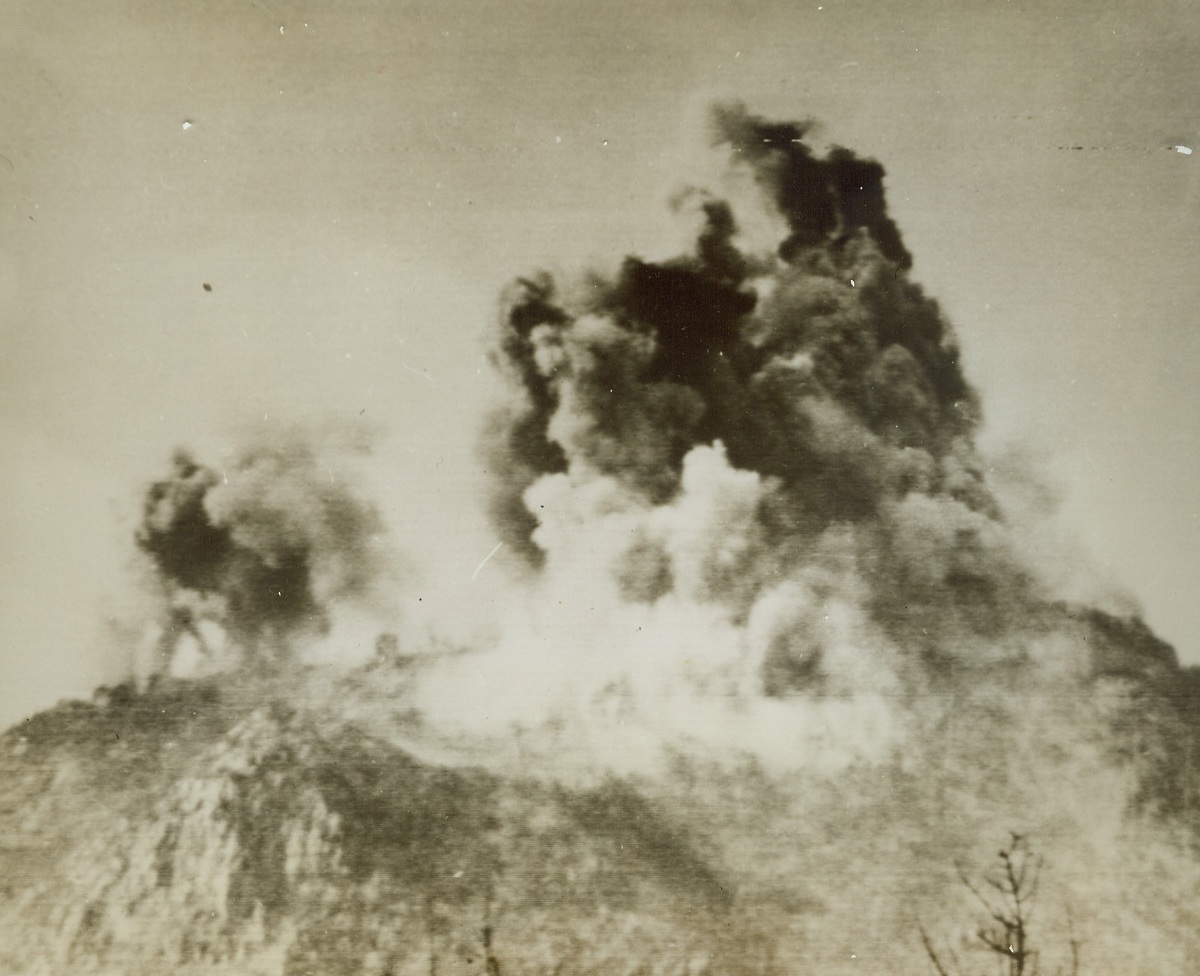 YANKS BOMB MONASTERY, 2/19/1944. CASSINO, ITALY—Here is a view of an American raid on the St. Benedictine Monastery at Cassino after Nazi forces had converted the ancient house of worship into a fortress to halt the advance of the Allied Fifth Army. B-25 bombers of the Allied Air Forces and Fifth Army artillery blasted the religious structure. Credit (U.S. Army Photo via Radiotelephoto—ACME);