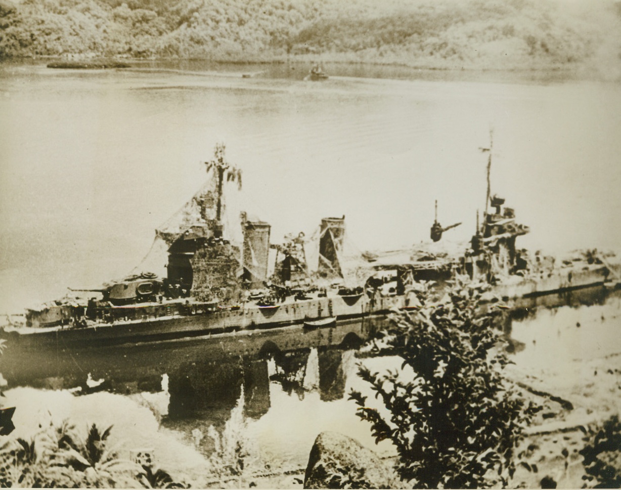 Has Shed Her Cobwebs, 2/26/1944. Tied up in Tulagi Harbor after she was badly damaged in the battle for Tassafaronga, November, 1942, the cruiser Minneapolis wears a “cobweb” camouflage dress over her super structure as she awaits repairs enabling her to journey to Pearl Harbor and then San Francisco.  Now, the gallant cruiser is back in the U.S. Navy offensive against far-flung Japanese bases in the Pacific.Credit (Official U.S. Navy photo from ACME);