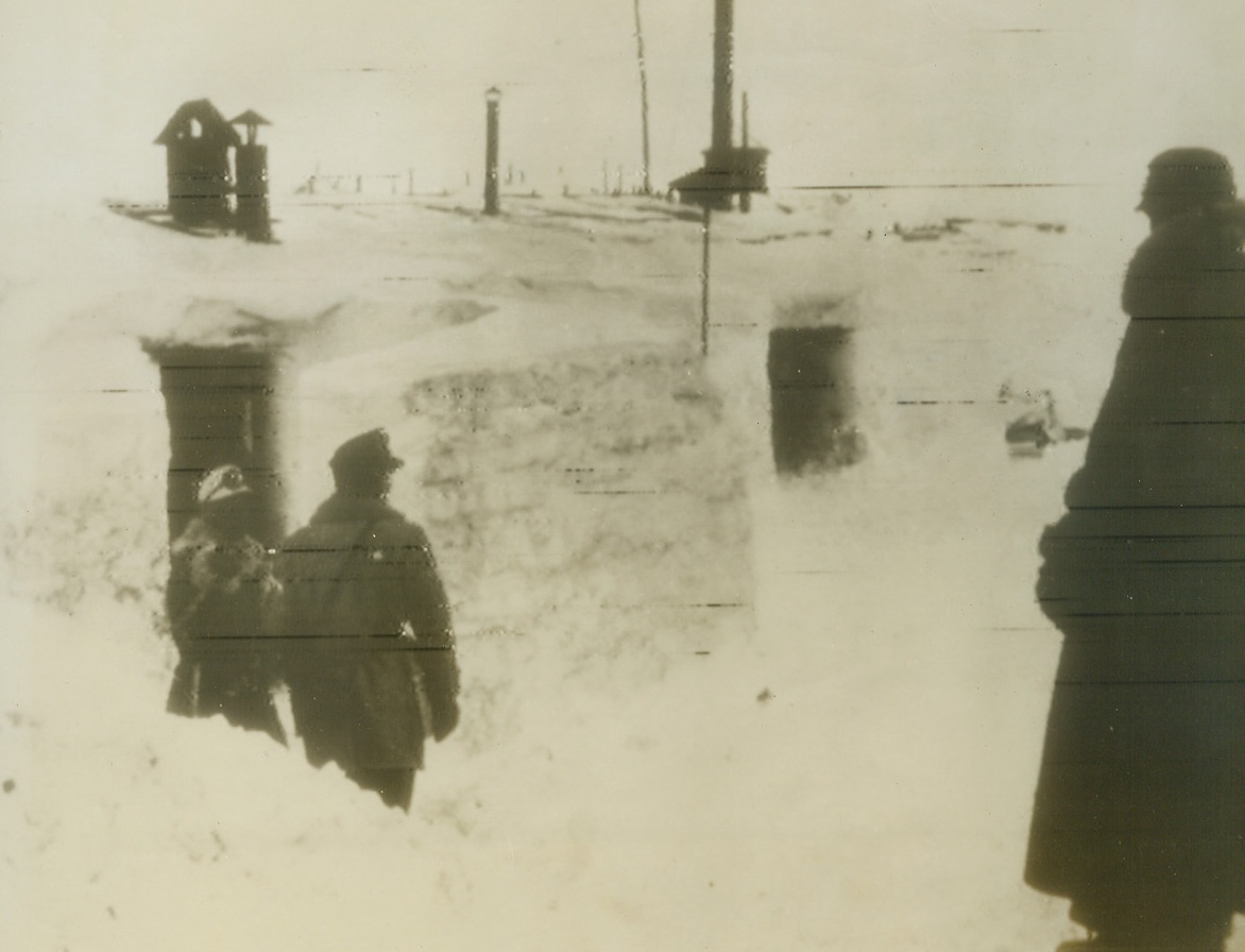 Ready for a Hot Time on a Cold Front, 2/8/1944. FINLAND—Nazi soldiers under command of General Dietl, German Chief of the Finnish Front, use ice walls and snow roofs to “insulate” their wooden barracks from the piercing cold. As Russia promises heavier blows at Finland, the snowbound Nazi fighters may soon see grim action. Photo flashed from Stockholm to New York.Credit: ACME;