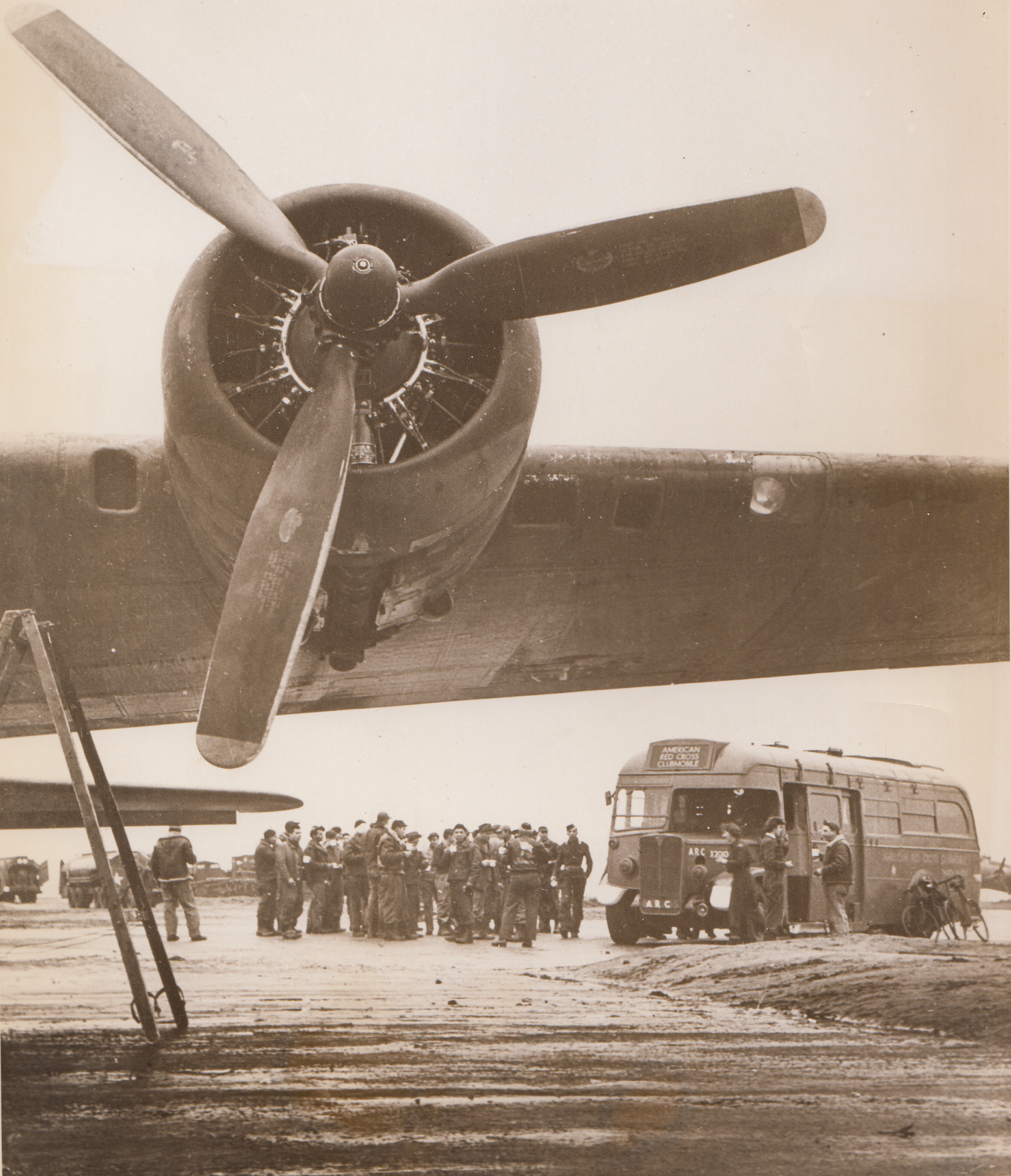 Clubmobile Gals, 2/19/1944. Somewhere in England—Based at a large, 15th century mansion owned by an English Earl and his Countess, four American Red Cross girls staff a Clubmobile bus, one of 51 such mobile canteens operating in the British Isles. Katharine Spaatz, 22-year old daughter of Lt. Gen. Carl Spaatz, is one of them. Pounding their “beat” of several camps and airfields within easy riding distance of their base every week, the girls hand out doughnuts and coffee and generally serve as morale boosters for their G.I. customers. This series shows the quartette at their jobs. ... The Clubmobile’s first stop is a flying fortress base, and girls put on recordings as their “bus” drives up. Music blaring from the loudspeakers, fore and aft, draw Yanks to the “wagon” for coffee, doughnuts, smokes, and chatter. Two girls serve the men while the other two busy themselves inside.;