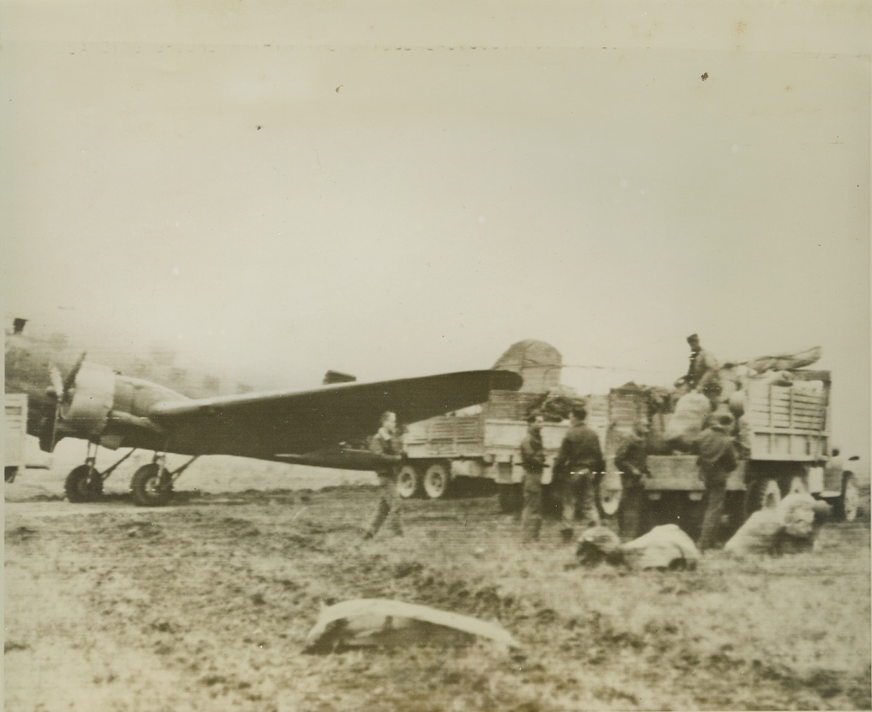 Air Mail, Special Delivery, 2/14/1944. Italy—Crew members empty the capacious hold of their 12 Army Air Force troop carrier  plane and load the supplies on a truck to be rushed to Fifth Army fighters at the Anz I-O front. The ship is on a newly constructed landing strip within the south of Rome bridgehead area.  Credit: Signal Corps radiotelephoto from ACME;