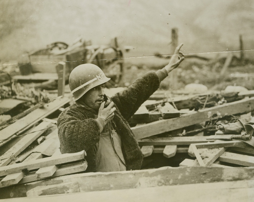 No Taxis Here, 3/29/1944. ITALY -- Under pressure of enemy artillery fire Pvt. William McGunnis, Huntington, W. Va., an M.P. of the 34th Division, was forced to "dig in" for safety while performing his traffic duties on the Gustav Line, north of Cassino, which today still remained in German hands. Allied forces, however have succeeded in maintaining their vantage points surrounding the city. Credit (Official US Army Photo from ACME);