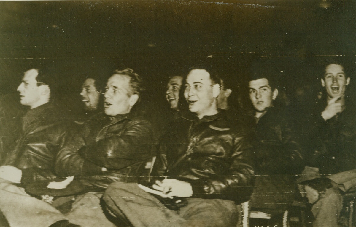 BERLIN ASSIGNMENT DRAWS CHEERS, 3/8/1944. A few seconds before this photo, which was flashed to the U.S. by radio today, was made crew members of this Flying Fortress group were told they were to bomb Berlin. Were they downhearted? Look at the smiles on their faces, as they cheer the news! Credit: USAAF photo via radiotelephoto from Acme;