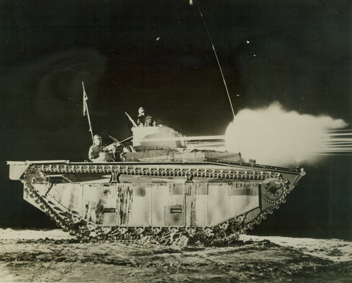 New "Water Buffalo" Packs a Wallop, 3/9/1944. WASHINGTON, D.C.-- In this photo, released by the Navy Department in Washington today, the 37mm. cannon and two 50cal. machine guns of a new LVT (A)-1 amphibious tank fire in unison to send streams of steel out over the test firing range. Illuminating the "Water Buffalo" with the glare. The new hard-hitting tank, similar to its predecessors except that it has its 37mm. cannon mounted in a turret, has already played an important role in the invasion of Jap strongholds in the Pacific. The vehicle, through its ability to travel with ease in water or on land, is a valuable invasion asset. Credit: (Official U.S. Navy Photo from ACME);