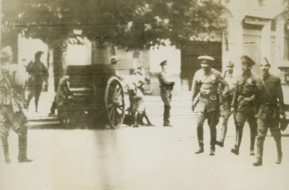 Soldiers in the Streets, 3/3/1944. Buenos Aires—There were soldiers in the streets of Buenos Aires again last week as Argentina’s nationalist military clique, which had opposed breaking of relations between Argentina and the Axis, staged a bloodless Coup D’Etat. Here, on Lomas de Zamora Street in a suburb of Buenos Aires, soldiers guard a field piece, keeping it ready for action. Credit: ACME radiophoto.;