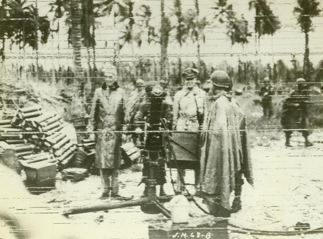 MacArthur in Admiralty Islands, 3/2/1944. Manus Island—Vice Admiral Thomas C.Kinkaid (Left) and General Douglas MacArthur (Second From Right) inspect a 50 Cal. Anti- Aircraft- machine gun at Momote bay, Manus Island, after American forces had occupied the island in the admiralty group, last Feb. 29th. Gen. MacArthur, supreme allied commander in the southwest Pacific, had watched the invasion of the Jap-held islands from a bridge of one of the vessels of the task force and had landed soon after elements of the first U.S. Cavalry Division (dismounted) had landed on Manus. 3/2/44 (ACME);