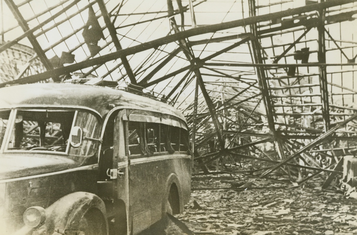 French Underground Scores Again, 3/28/1944. Grenoble, France – When German occupation troops refused an ultimatum from the French Underground demanding the release of hostages seized after French patriots had blown up the Artillery Park and Arsenal at Grenoble, Nov. 13, 1943, the Underground blew up the Barracks “De Ronne” killing 220 Germans outright, and wounding 500. Part of the wreckage of the blasted barracks and a motor garage are shown in this photo, smuggled out of France and just released in the United States. (Passed by Censor) Credit: ACME;