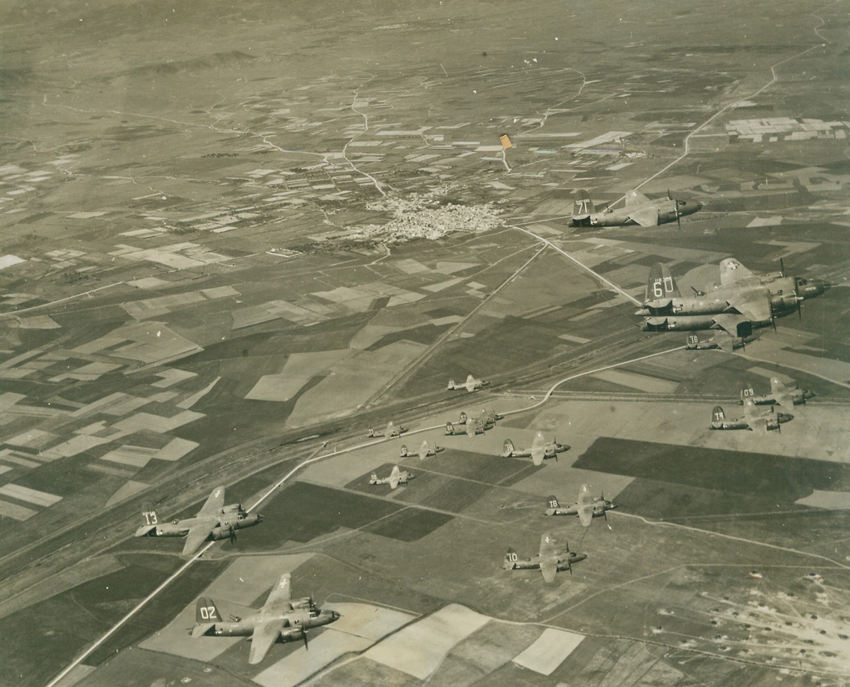 Air “Squeeze Play” on Axis (#2), 4/24/1944. SARDINIA – Hitler’s “Festung Europa” today, is being shattered and rocked by the greatest concentration of aerial might the world has ever seen. Day after day, in mounting numbers and with ever-increasing ferocity, huge masses of Allied bombers and fighters are blasting German war plants, communications, and airfields into crumbling and smoking ruin in preparation for “D Day” – and Allied invasion. These aerial armadas have occupied Europe in a gigantic pincers, with one “leg” in England, and the other in Italy and Sardinia. This series of photos shows U.S. B-26 Marauders taking off and operating from Allied fields in Sardinia, against the Southern Coast of France. Their target was the Var River railroad bridge near Nice.---Here, in Marauders swing into formation above their base.Credit Line (Acme Photo by Charles Seawood for the War Picture Pool);