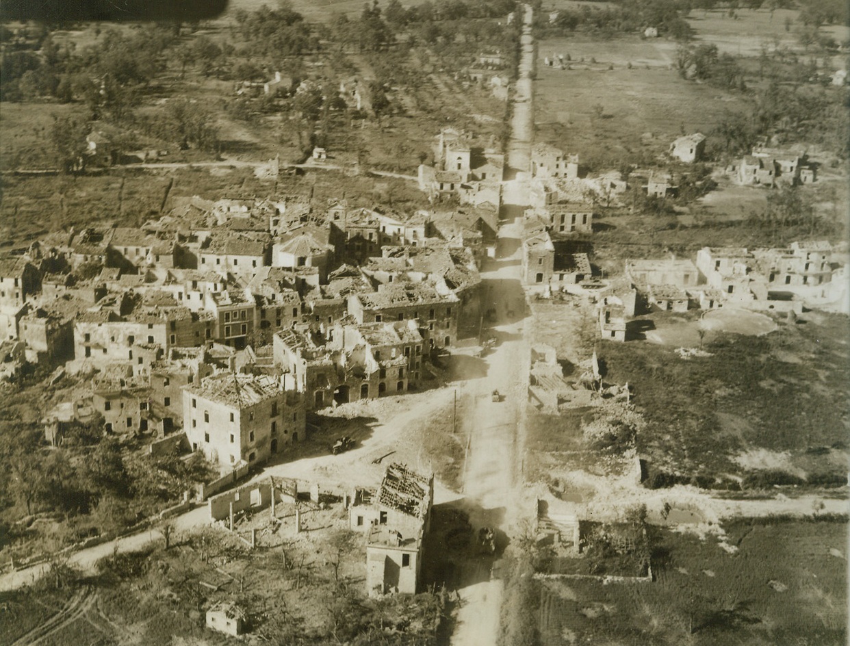 On the Road to Rome, 5/25/1944. Italy – Allied mechanized troops can be seen traveling this road through the Italian town of San Giorgio after its recent capture by Allied troops. The progress of the Fifth Army forces is marked by shellfire, smoked-in positions and shell-shattered and bomb wracked Italian towns. Credit: (ACME) (WP) (Photo by Charles Seawood, War Pool Correspondent);