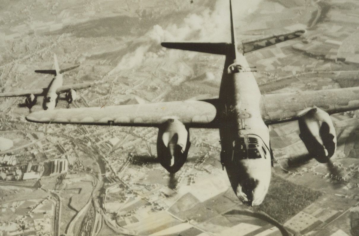 Bomb Belgian Rail Yard, 5/12/1944. BELGIUM—B-26 Marauder bombers head for home after a successful bombing tour of the railway yard and power station at Charleroi, Belgium, 30 miles south of Brussels. Yesterday medium bombers like these hammered Nazi coastal fortifications in France and Belgium. Allied bombers have blasted the invasion coast for 27 consecutive days—crippling the Nazi transportation system.  Credit: US ARMY PHOTO FROM ACME.;