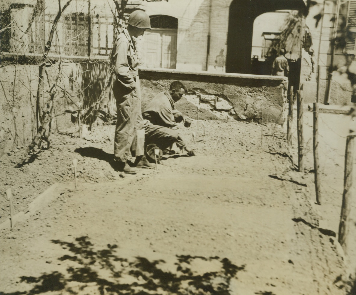 Victory Garden at the Front, 5/2/1944. ANZIO, ITALY—Digging in the dirt, planting seeds, and watching things grow is the pleasure enjoyed by these American soldiers at Anzio. It’s a lot different from digging fox holes and more fun. This is the only victory garden on the Anzio beachhead hand in it tomatoes, beans, and potatoes have been planted. Pfc. Richard C. Woodward, Oklahoma City, Okla., looks on while Sgt. George O. Edmonds, Charleston, West Virginia, does some planting.;