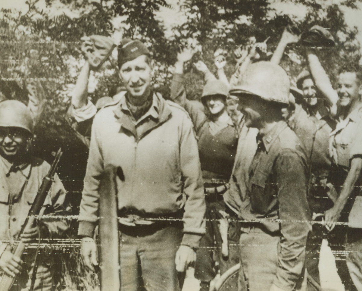 CHEER GEN. CLARK AS TROOPS JOIN, 5/25/1944. ITALY—Gen. Mark Clark is cheered by Yank and British troops surrounding him as the Fifth Army merged its two fronts today for a unified drive on Rome. Gen. Clark, arriving with British troops, was the first American officer to reach the meeting place. Credit: British official photo via OWI Radiophoto from Acme;