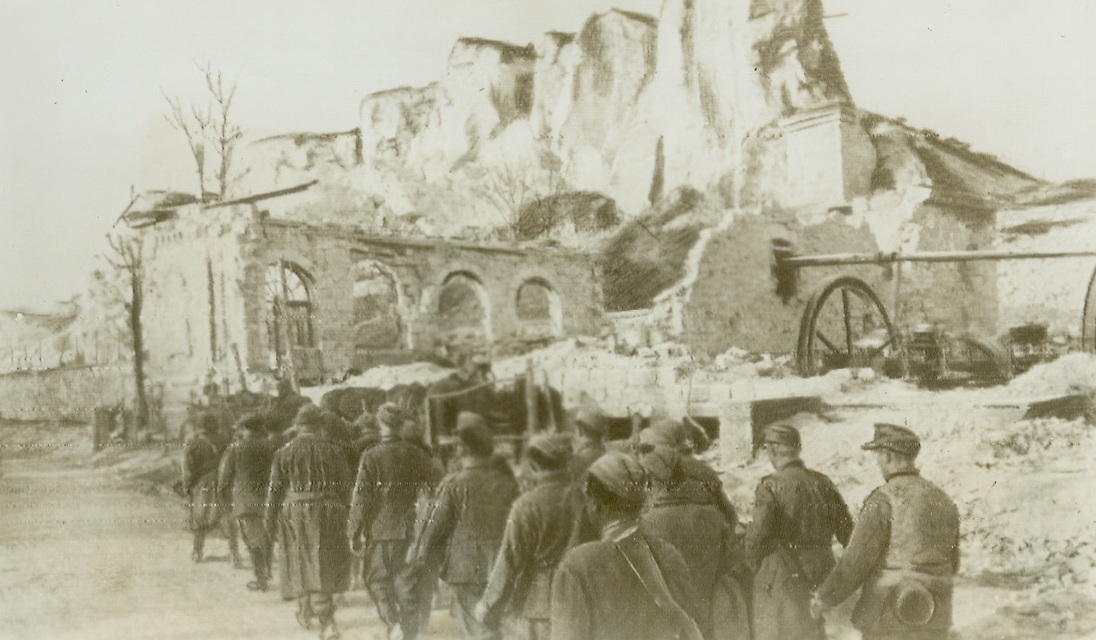 The Bitter Taste of Defeat, 5/14/1944. SEVASTOPAL – German and Romanian prisoners trudge wearily through the battle-scarred streets of Sevastopol, tasting the bitter gall of defeat. Their cherished dreams of becoming masters of the Crimea were shattered forever when hardy Soviet troops stormed the beloved city, after weeks of fighting on the outskirts. Having gone through two sieges – once when the Germans took it form Russian, and again when Russia reclaimed it, Sevastopol is only a shattered wreck of the proud city that once graced the Crimea.Credit (ACME Radiophoto);