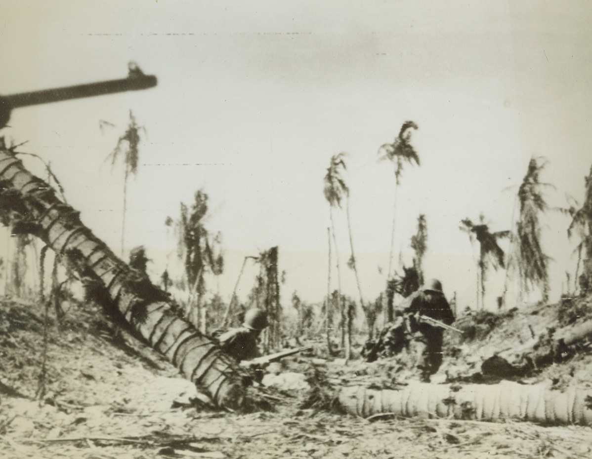 Mopping Up on Wakde, 5/23/1944. Two members of the U.S. invasion force move forward against last pockets of Jap resistance, after the invasion of Wakde Island, off the coast of Dutch New Guinea. Caught by surprise, the Nips offered comparatively little resistance and the Yanks are now in full possession of the area, including an excellent airfield. Credit: ACME photo by Frank Prist for the War Picture Pool via Army Radiotelephoto;