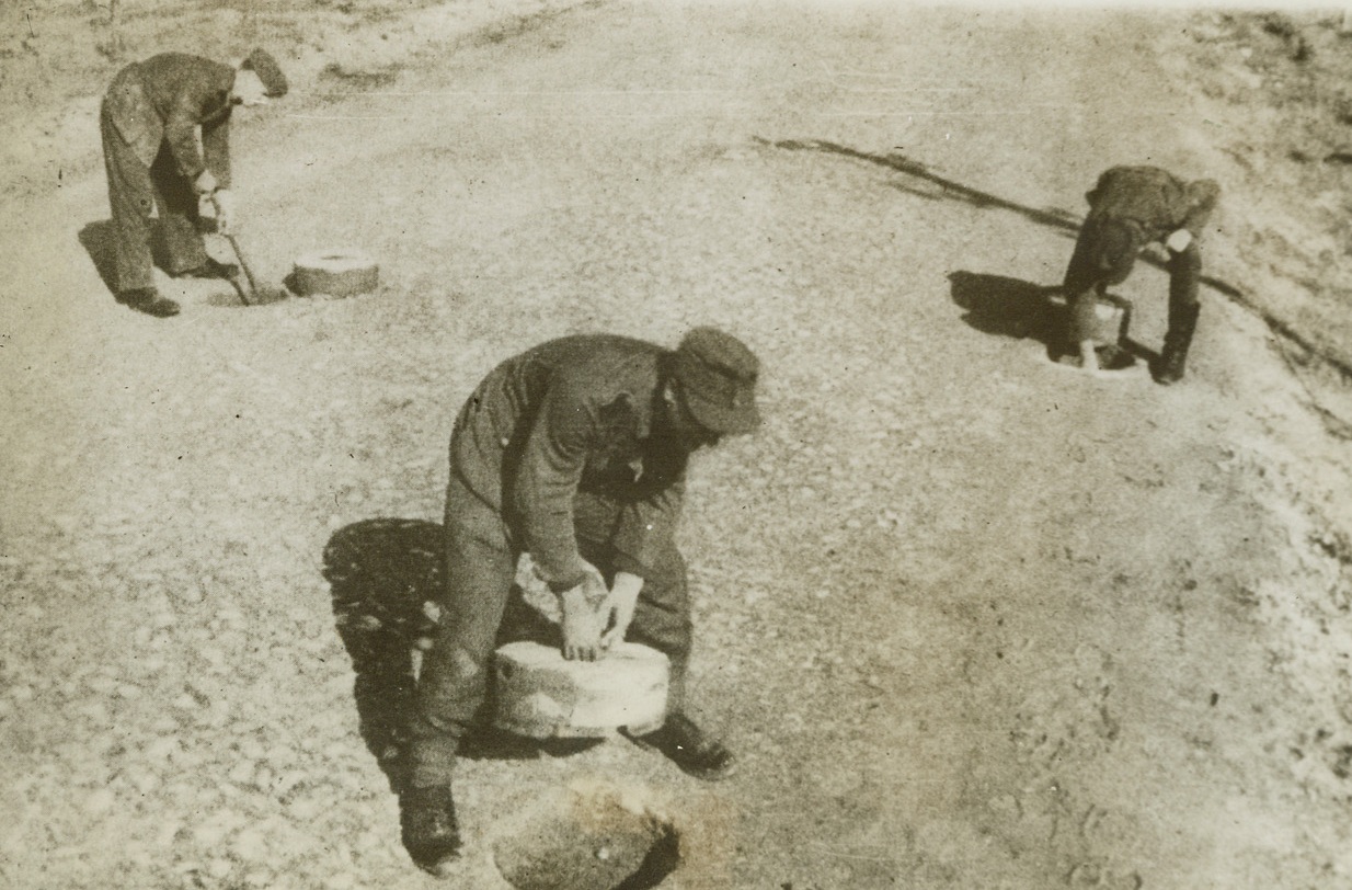 Nazis Plant Garden of Trouble, 5/22/1944. France – In their effort to impede the advance of Allied forces making the sea-borne assault on Europe, the Nazis have transformed the peaceful French coast into a complicated labyrinth of anti-invasion defenses. A beach road is shown being mined by German Sappers. Credit: ACME;