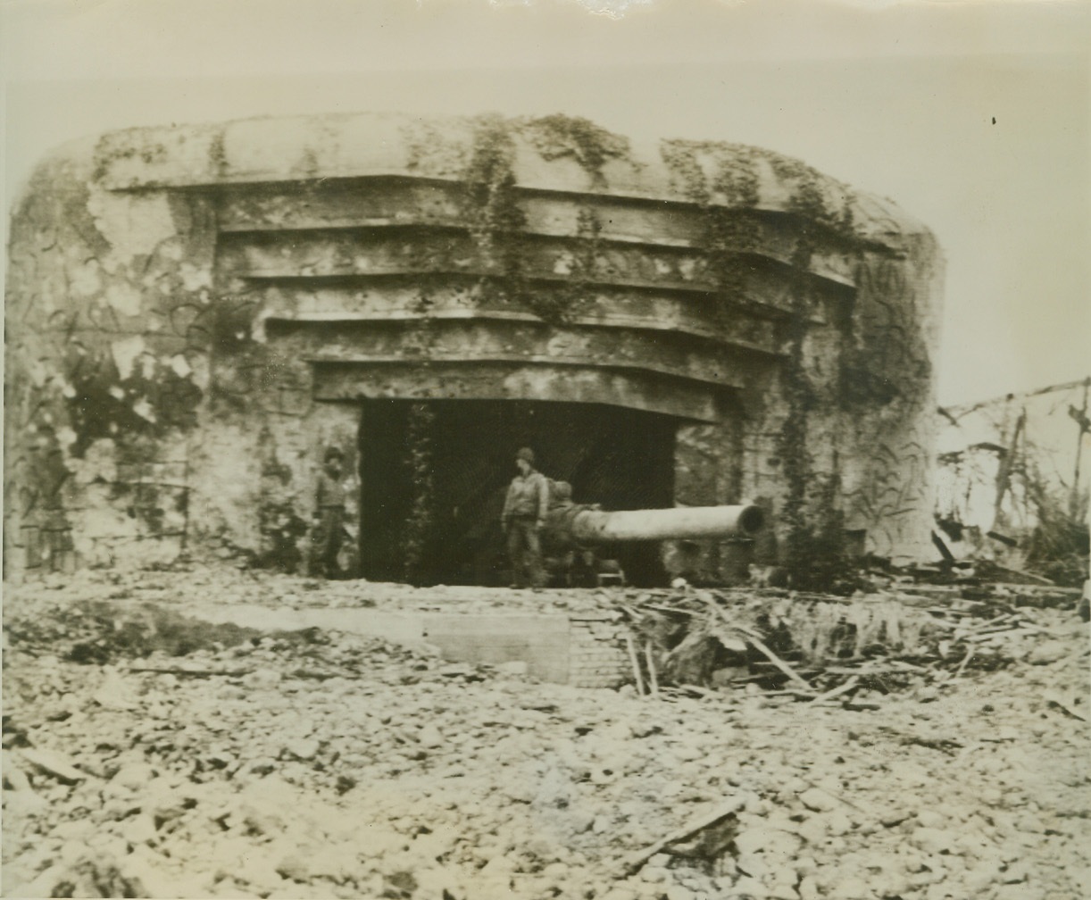 The Gun that Failed, 6/18/1944. SOMEWHERE IN FRANCE -- This oversized German naval gun, planted on the Channel  coast of France, was one of many that failed in their jobs of protecting the Cherbourg peninsula from advancing Allied forces. The defensive gun was quickly put out of commission by naval and artillery fire.  Credit (ACME Photo via U.S. Signal Corps Radiotelephoto);