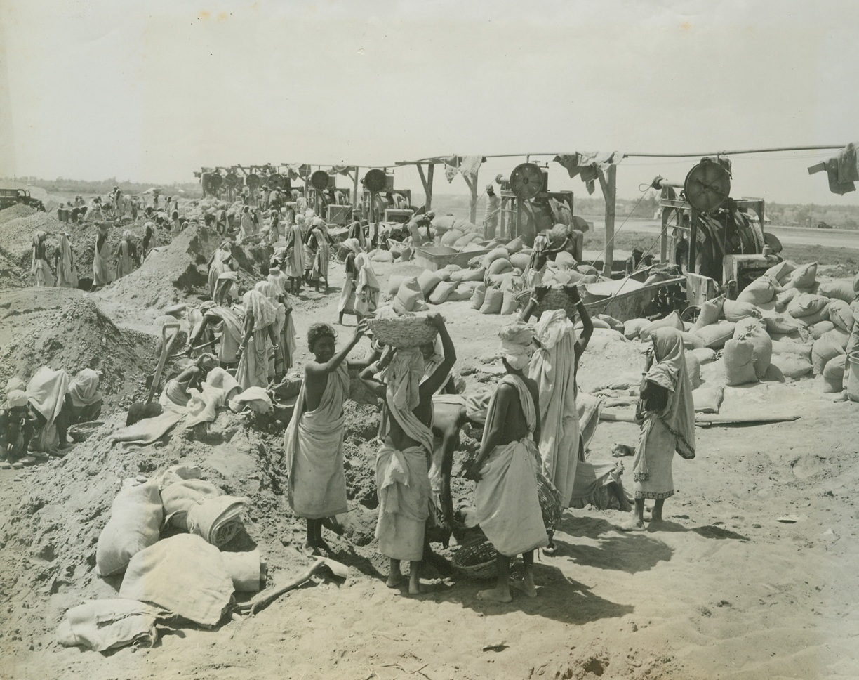 Indian Natives Enlarge Airport for Bombing of Japan, 6/17/1944. Somewhere-in-India, B-29 bombers, America’s newest air weapon were tuned up at a base in India and from there started on their mission to bomb the steel center of Japan on June 15th. The photos were shipped from India on June 12th and were received in Washington, June 17th due to the expediting by the air transport command.  Here are the native Indian as they worked to enlarge the airport to provide the additional area necessary for the take-off of the super planes. Credit line (ACME photo by Frank Cancellare for the War Picture Pool);