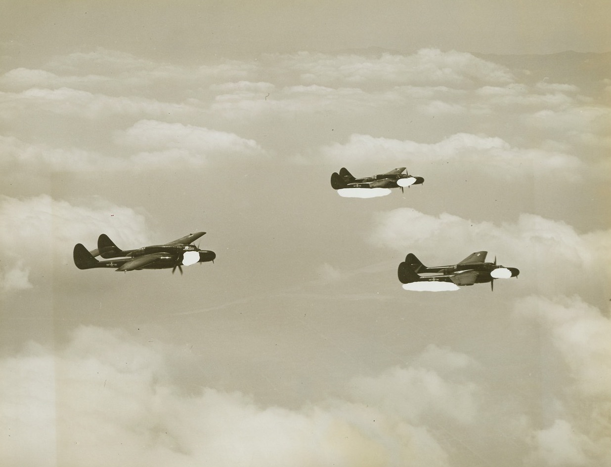 “Black Widow” Comes Out Into Light of Day, 6/13/1944. Hawthorne, California - Recently announced by the Army Air Forces, pictures of the new Northrop P-61 “Black Widow” Night Fighter have just been released. Armed with everything but the kitchen sink, the Black Widow is literally a flying gun platform and is the first Army fighter revealed since Pearl Harbor as well as the largest and most powerful pursuit plane ever built. The Black Widow is the first functional night fighter of the war. Planes used for night fighting - some with great success- have been modifications of aircraft originally planned for other types of missions and have lacked top efficiency in night battle. The P-61 was started in 1941 and an experimental model first test-flown in May 1942. Reminiscent of the P-38 with its twin fuselage, the Black Widow is equipped with the latest night fighting equipment and powered with two Pratt and Whitney Engines. As a night fighter it develops pursuit speed while retaining the easy flying characteristics and low landing speed necessary for night operations. All these pictures have been censored by the Army Air Force, and the blank spots indicate where deletions have been made. Looking somewhat like the P-38 Fighter, the “Black Widow”, newest night flyer takes to the skies in this flight of three of the powerful aircraft. Black spots indicate censorship. Credit: ACME;