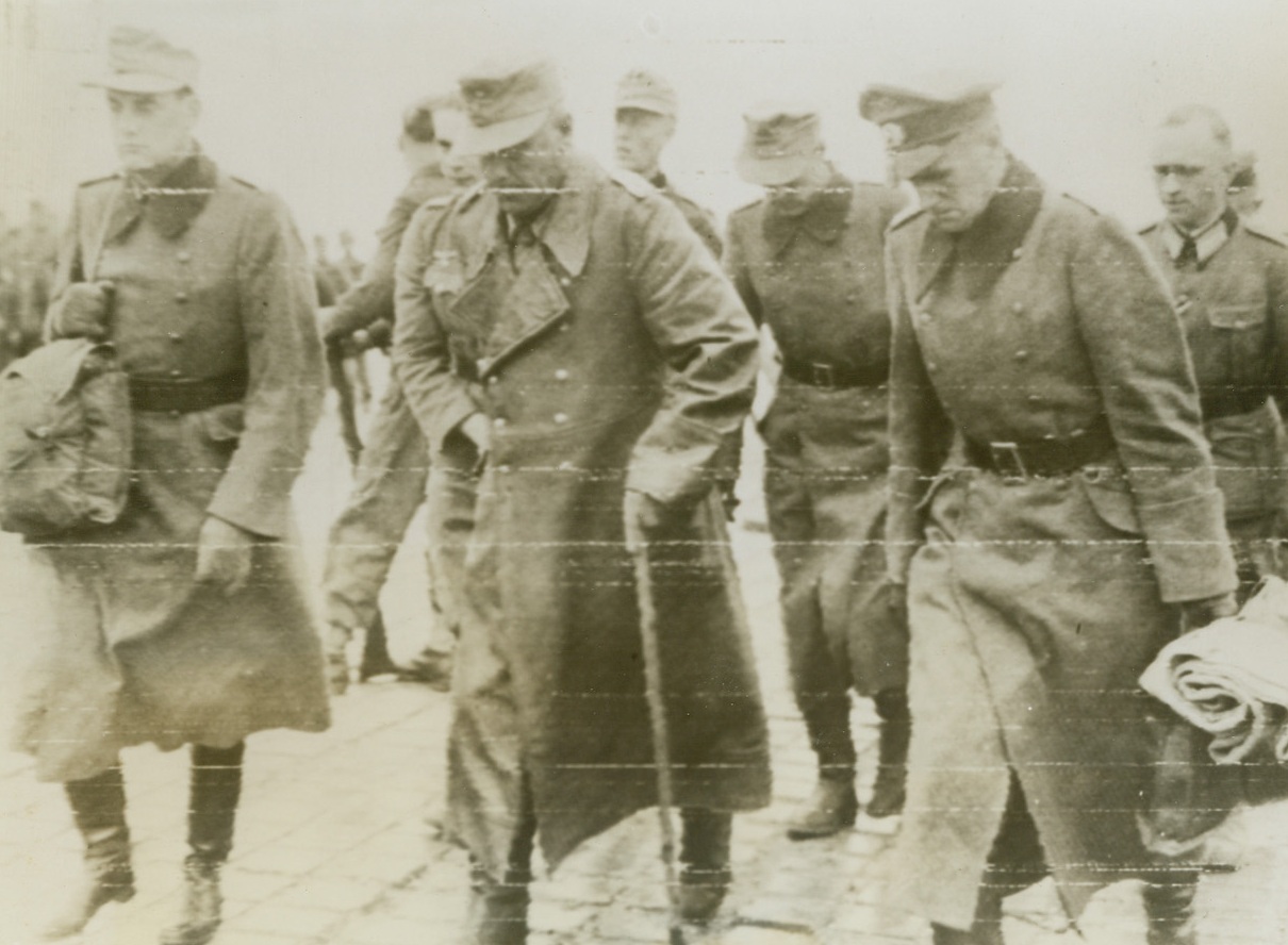 Nazi Officers Prisoners Of War, 6/10/1944. England – Their part in the struggle to impose the New Order on the peoples of the world over, these German officers march through England en route to a prisoner of war compound. They were captured by invasion troops in the battle for the Normandy beachheads. Credit: Signal Corps Radiotelephoto from ACME;