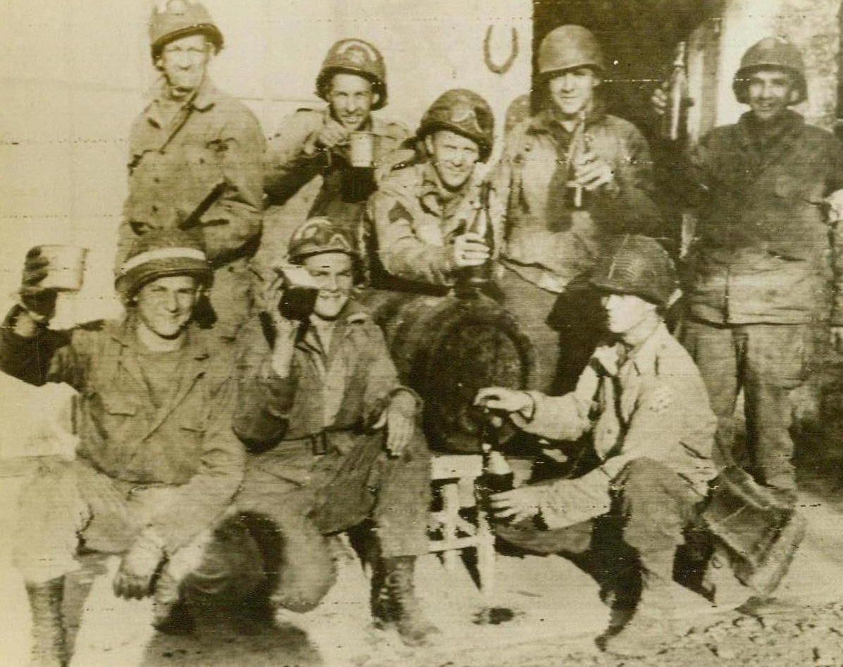 A Toast to Liberation, 6/14/1944. France—After they and their buddies had liberated this town along the coast of France, These U.S. soldiers received a barrel of wine from one of the thankful natives. Here, they drink a toast to the continued success of the Allied liberation of France 6/14/44 (RadioPhoto);