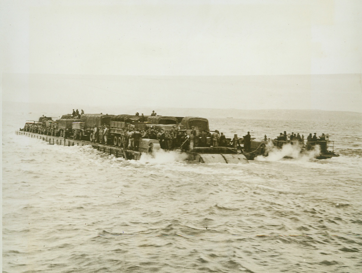 Calling all Engines, 6/6/1944. CHICAGO, ILL. – The familiar phrase, “Calling all cars”, used in police radio, may soon have its counterpart in railroading for two-way communication in high frequencies is now in use for the first time on engines of the Rock Island, Ill., lines. Their present installation of transmitters and receivers, operating at 10 watts in the 40 megacycle band of frequencies, is in use only in the Burr Oak freight yards near Chicago. Now the freight yard master can talk with engineers in switch engines, relaying orders and getting information on the whereabouts of engines. Called WXIOTL, the station has an operating radius of 25 miles. The railroad has FCC permission to install high frequency systems for communication between train engines and cabooses, yard and yard dispatcher and trains. New York Bureau Here, the twin 143-HP, Chrysler marine outboards at either end of the stern churning up the sea, the “rhino ferry” heads for shore loaded with motor vehicles and supplies, after loading from a transport. Credit: (U.S. Navy Photo from ACME);