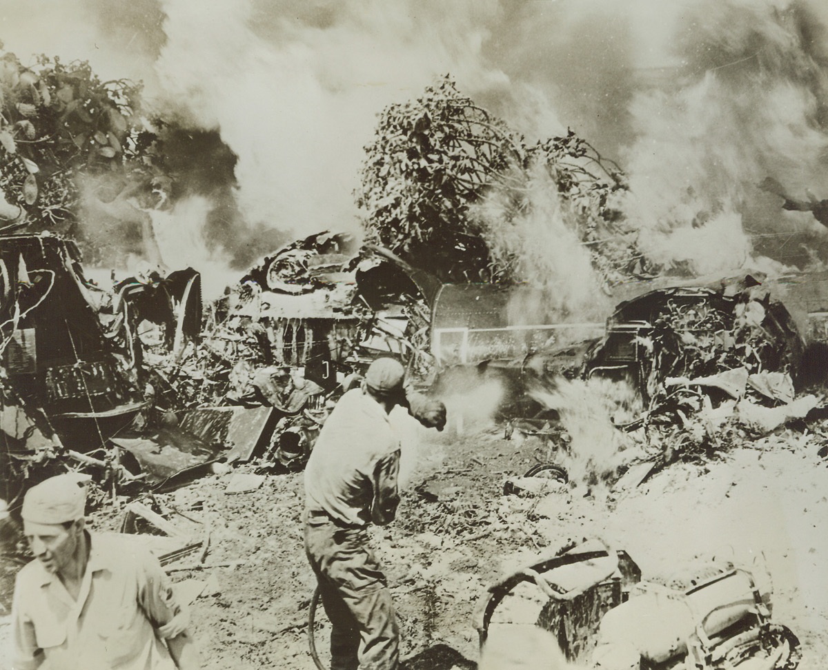 Crew Saved from Burning Liberator, 7/20/1944. ITALY—When this 15th Air Force B-24 Liberator bomber crashed at a field in Southern Italy, ground crew men rushed in and pulled the plane’s crew to safety. No one was killed as a result of the crash. A short while afterward, the aircraft’s gas tanks exploded ravaging the ship. Emergency crews could do nothing to save the Liberator and worked hard keeping the flames from spreading. Credit: USAAF Photo from ACME.;