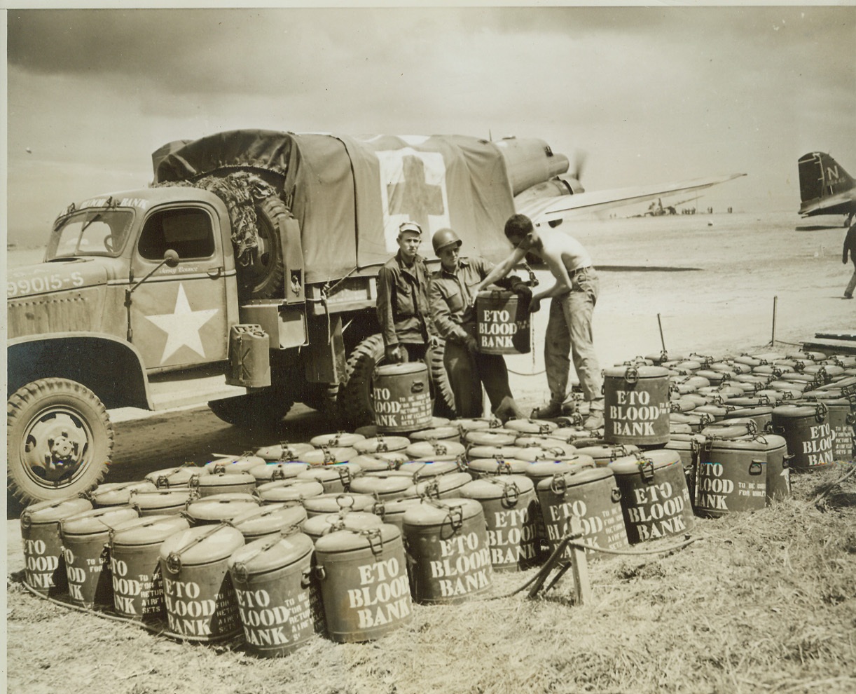 Blood for Wounded Americans, 7/22/1944.FRANCE -- Sealed containers of blood for transfusions to wounded Yanks are lined up in a field in Normandy after being delivered by transport plane. This life-restoring fluid has already saved and will save many lives. While American soldiers in France are giving their lives for the cause of freedom, civilians can also play a vital role in that cause by giving blood to the American Red Cross Blood Bank. In this simple and painless way, each civilian can feel that part of him or her has reached a fighting front and has helped to save some soldier's life. Credit-WP-(ACME Photo by Bert Brandt, War Pool Correspondent);