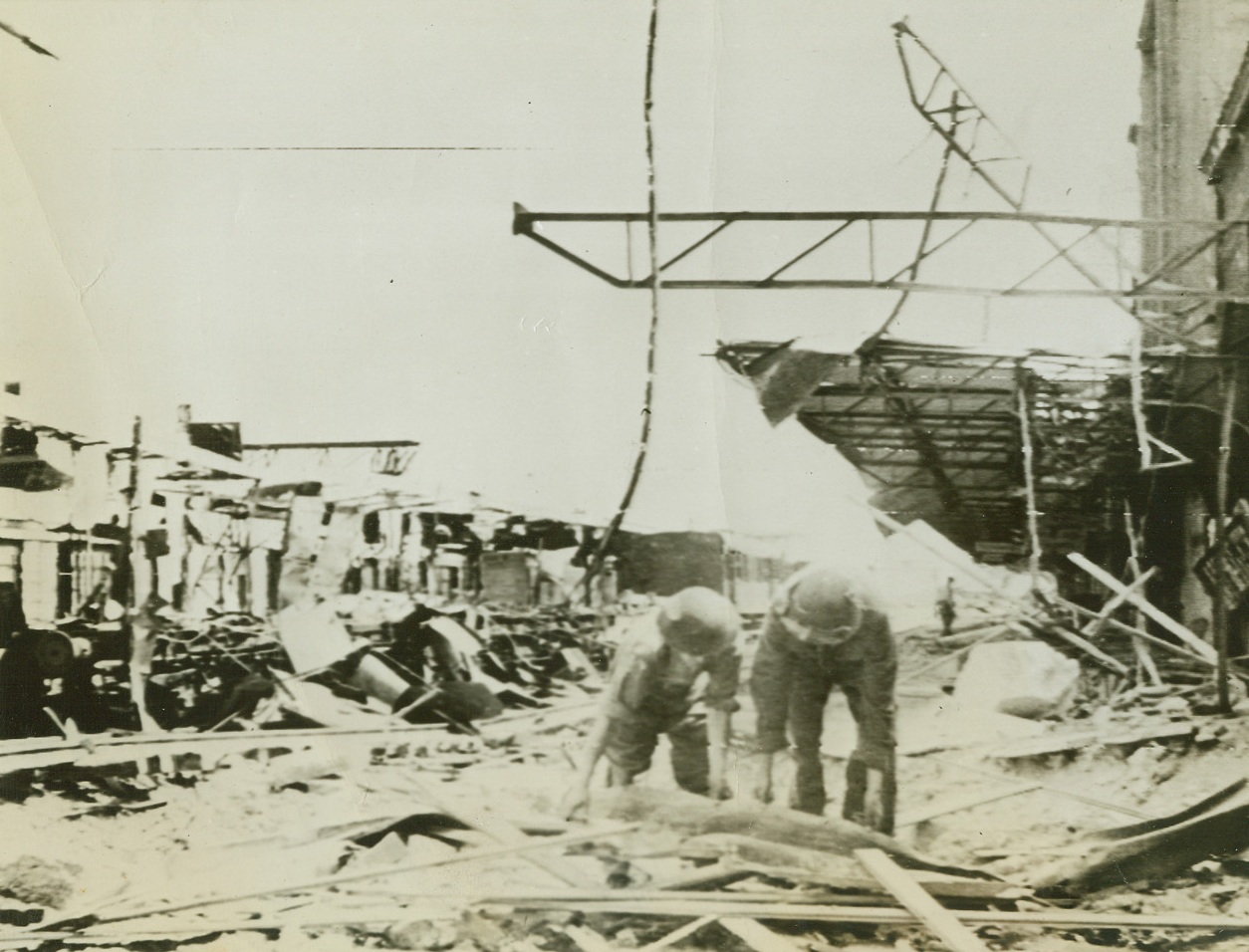 Railroad Repairs Under Way, 7/23/1944. Vaucelles, France – Canadian Army engineers remove the debris from the tracks at the Vaucelles railway station as they quickly repair the rail center for use by the Allies. Credit: Army Radiotelephoto from ACME;