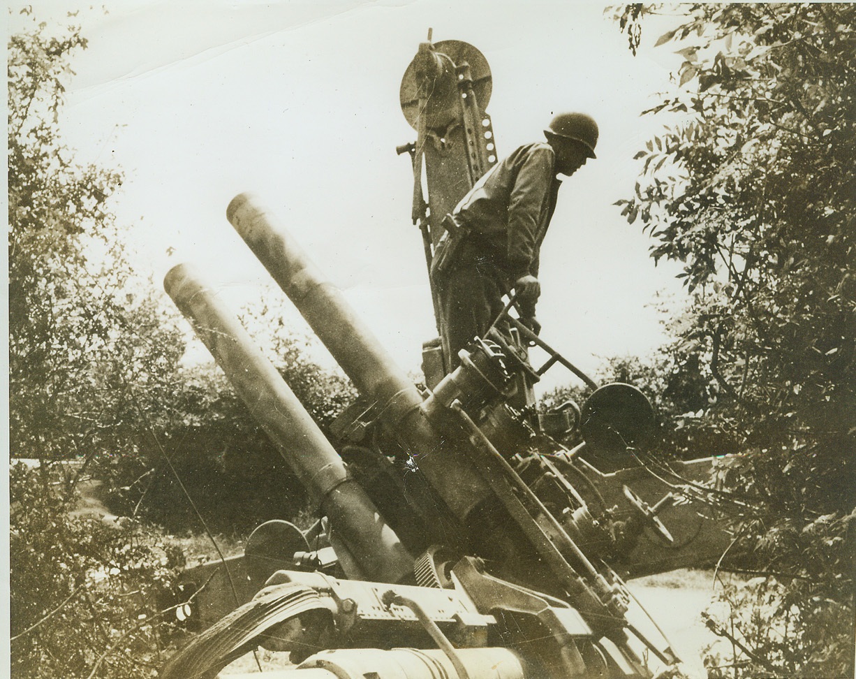 Two Halves Won't Make a Whole, 7/25/1944. NORMANDY, FRANCE -- Nazis fleeing before the American advance in Normandy, paused long enough to do an efficient job of smashing their 88mm gun (above) in halves before they abandoned it. Maj. James Owen, Junction City, Tex., examines the remains of the gun. Credit (ACME) (WP);