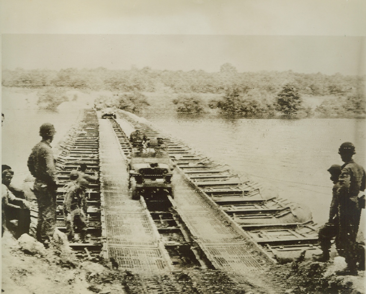 Patton Stays Up Front, 8/30/1944. France – A U.S. Jeep, carrying Lt. Gen. George S. Patton, rolls across a pontoon bridge over the Seine River on the heels of his rampaging 3rd Army. He was the first American officer to set foot on the northern bank of the historic river in this war. Credit (Army Radiotelephoto from ACME);