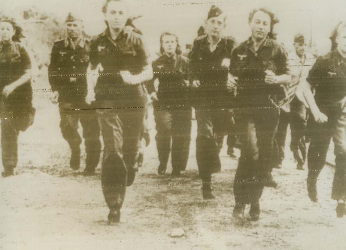 German Women Train for Anti-Aircraft Duty, 8/19/1944. In this photo, radioed to New York today (August 19) from Stockholm, German women work side-by-side with the men in training for work in ack-ack units. According to the German caption, these women will replace the men who will be released, under Germany’s total mobilization program, to fight at the front.  Credit (ACME Radiophoto);