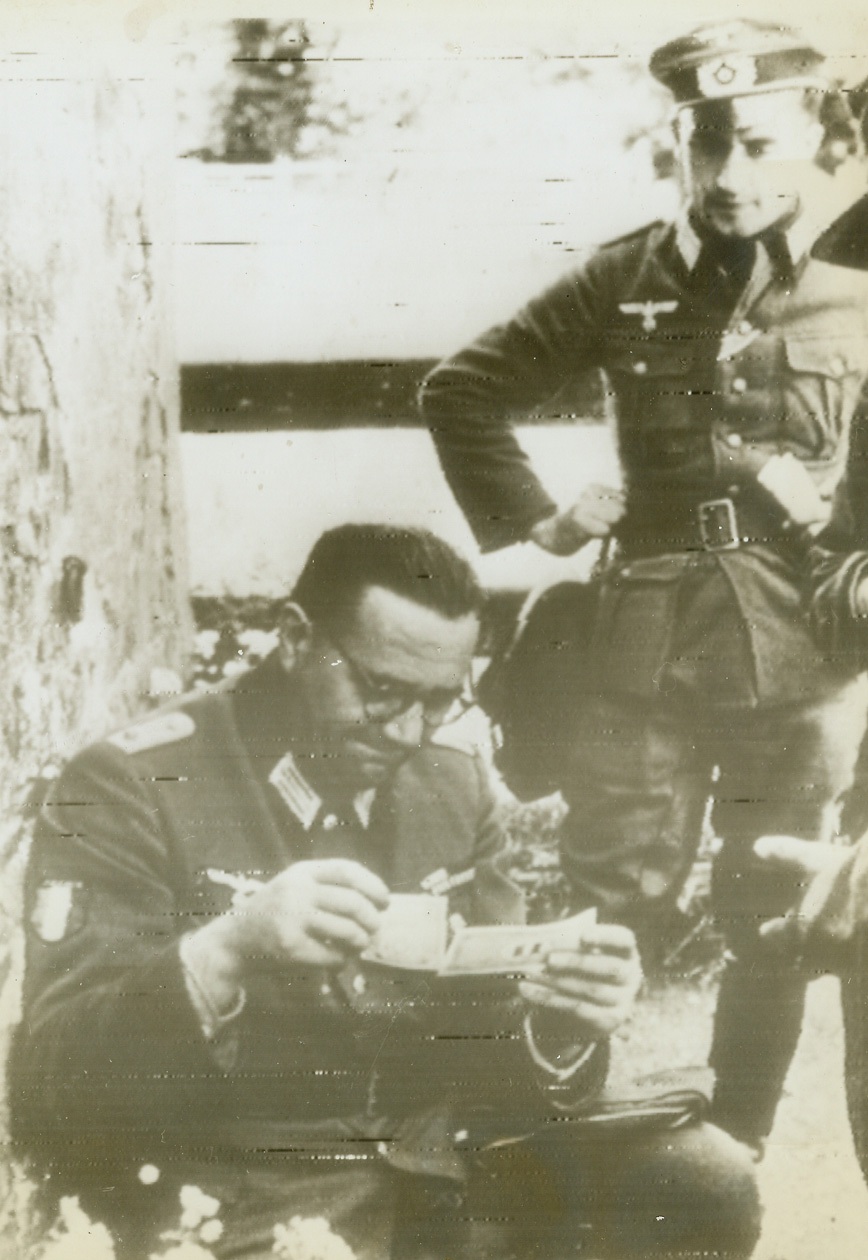 “Roosevelt’s Fake Money”, 8/4/1944. According to the German caption accompanying this photo, radioed today from Stockholm, Jacques Doriot, French Nazi leader attired in German uniform, examines invasion francs, dubbed by the German caption “Roosevelt’s fake money.”Credit (ACME Radiophoto);