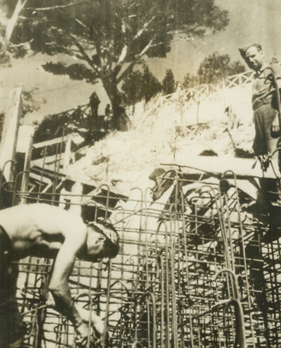 Defenses That Failed, 8/16/1944. France—The German caption describes this photo as “men working on partially completed Nazi defenses along the French Mediterranean coast” where Allied forces staged their surprise landings on August 15th, meeting no united resistance. Photo was radioed toNew York from Sweden today. Credit: ACME radiophoto.;