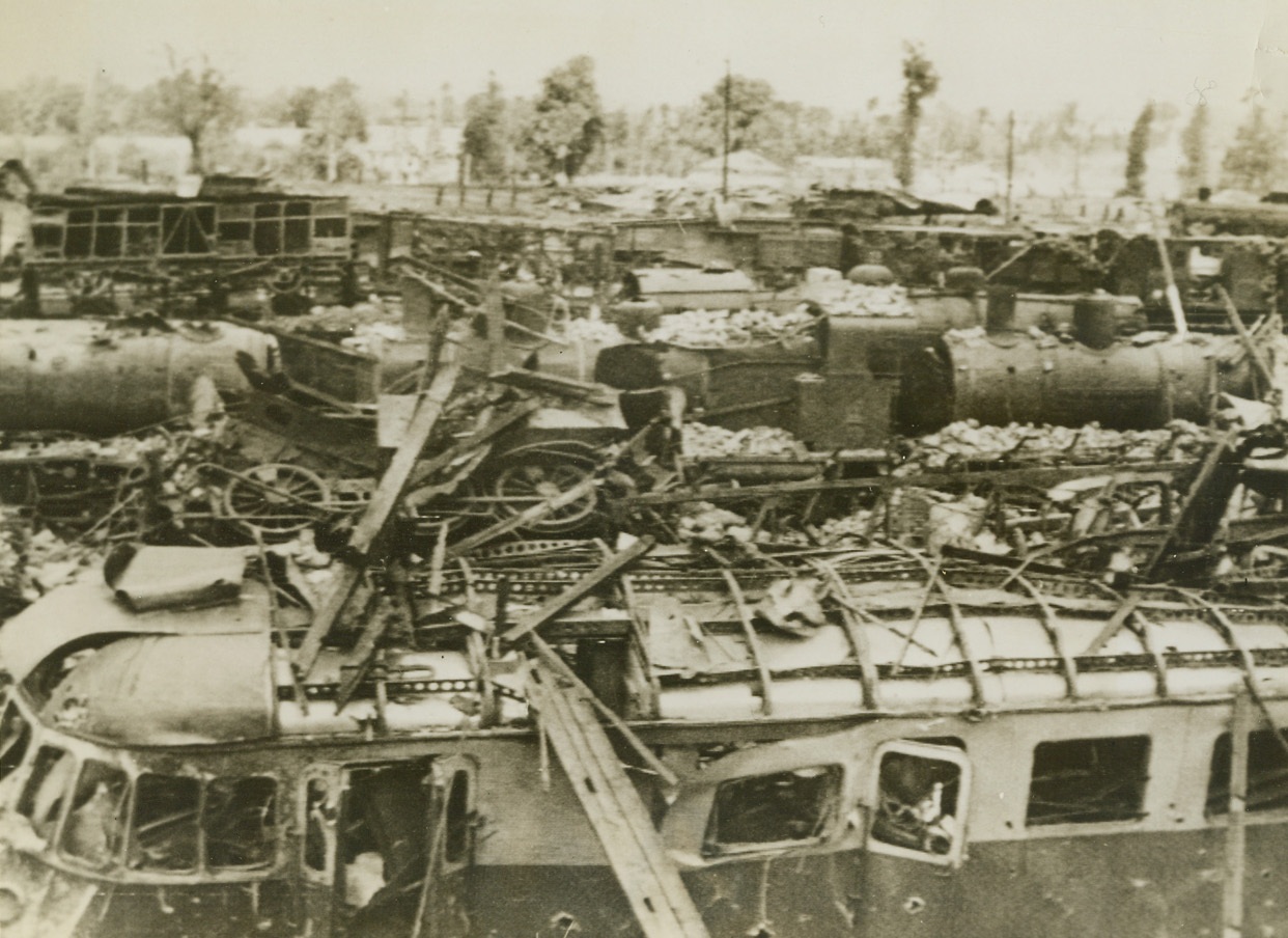 Another Nazi Communication Line Destroyed, 8/14/1944. Vire, France – Rolling stock and tracks in the Vire Railyard lie in shattered ruins after Allied Bombings which preceded the occupation of the city on August 7. Credit: British Official Photo via Signal Corps Radiotelephoto from ACME;