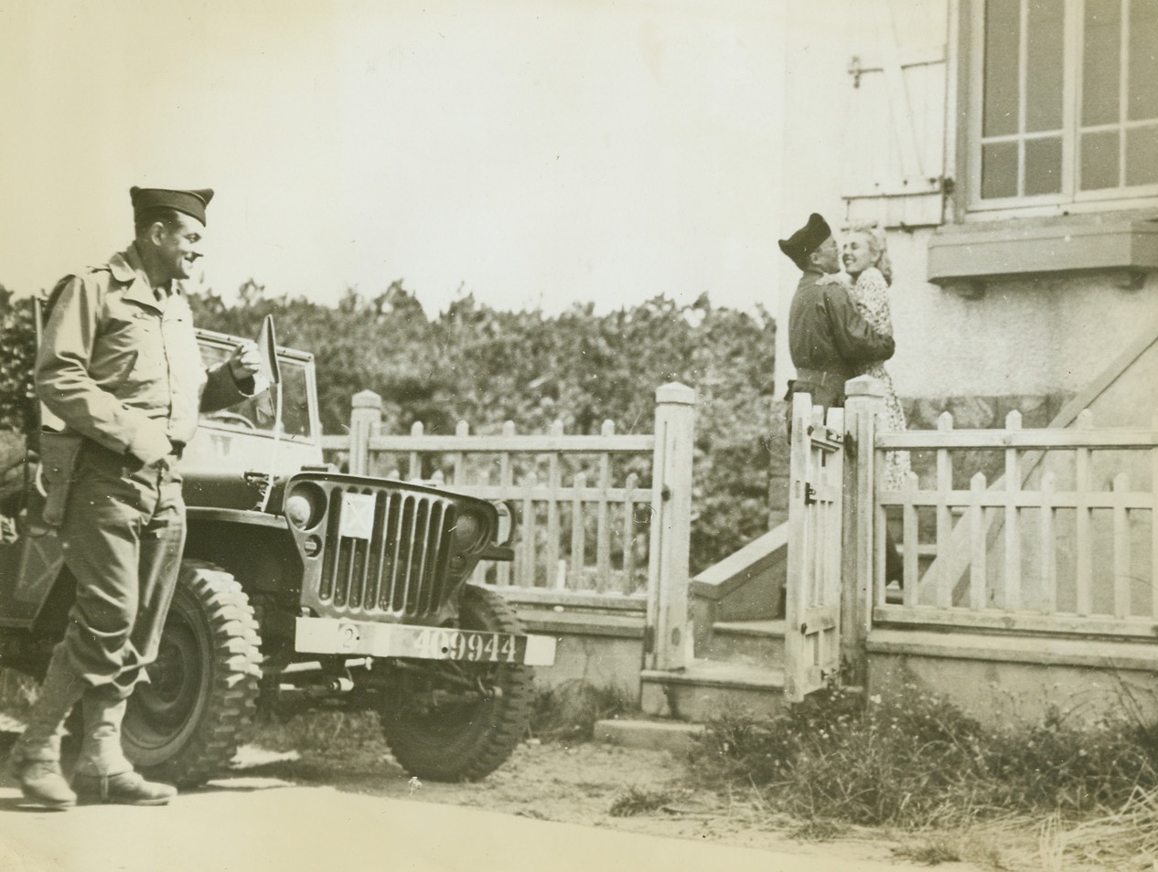 A Frenchman Returns To His Wife, 8/15/1944. Coutinville, France – Lt. Nonet-Raisin, of the 2nd French Armored Division, which once more is fighting in its homeland, happily embraces his wife at the door of their home, from which he fled in 1943 to join the Free French. Credit: U.S. Signal Corps photo from ACME;