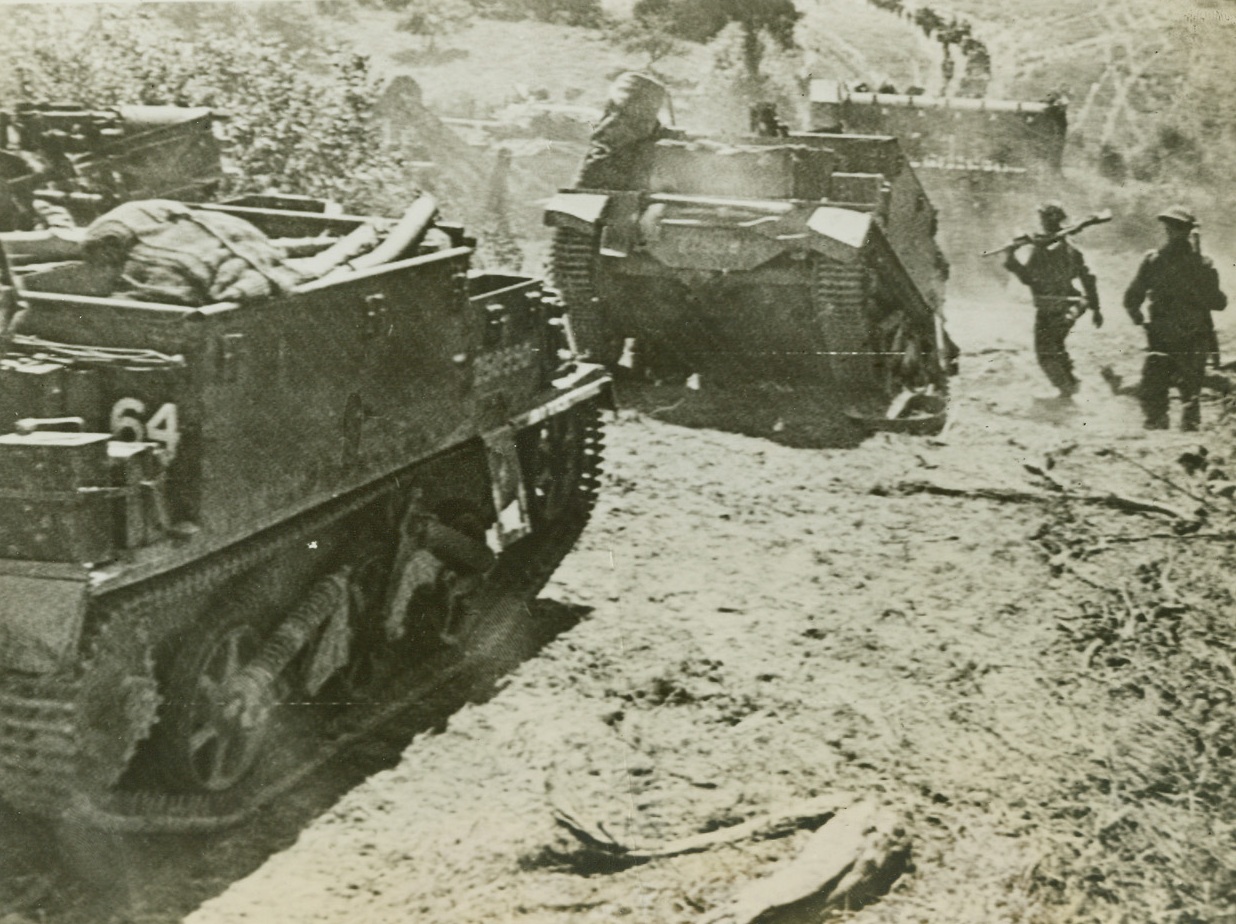 Forward On The Victory Road, 8/1/1944. Caumont, France – During a British attack on the Caumont area, infantry and armored vehicles move forward to the front lines, as the British offensive continues to advance. Credit: British Official Photo via US Army Radiotelephoto from ACME;