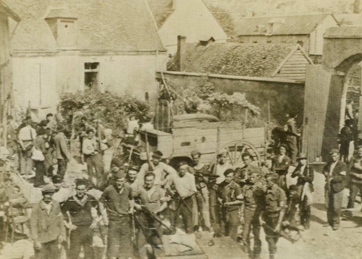 French Patriots Get Guns, 8/23/1944. France – In the yard of a farmhouse near Chateaudun, French patriots collect guns and ammunition and await orders to move on the fleeting Germans. Most of the arms were dropped to the patriots by Allied Airmen. Men like those gathered here were among the French Forces of the Interior, uniformed and not, who today freed Paris from Nazi rule. Credit: Army Radiotelephoto from ACME;