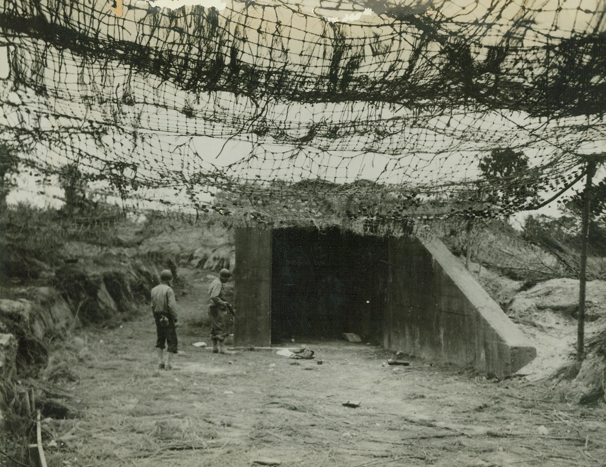 Jumping-Off Place For Robot Bombs, 8/8/1944. France – Allied soldiers examine the mouth of the ski building from which German robot bombs were to be launched for attacks on England. However, the building was left uncompleted when German workers fled in the face of the great Allied offensive drive. Credit: ACME;