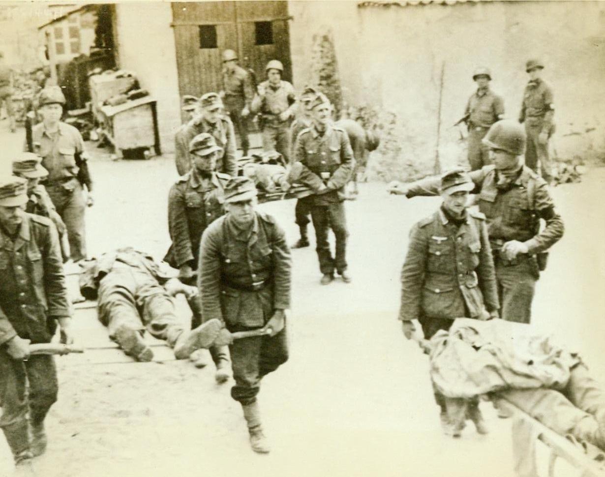 Germans Bury Their Own Dead, 8/4/1944. France—In solemn procession Germans carry their own dead for burial in a military cemetery at Brehal, France. Note the improvised litters bearing the dead Nazis. 8/4/44 (Acme RadioPhoto);